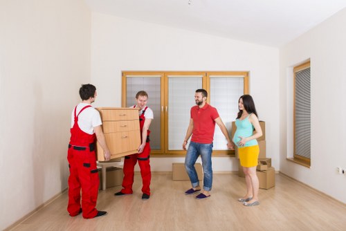Removal workers navigating stairs in a Pimlico apartment building