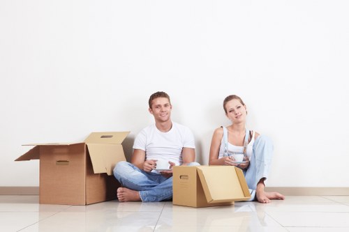 Professional movers carrying items through a Pimlico apartment building