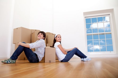 Professional movers handling boxes and furniture in a Pimlico flat move