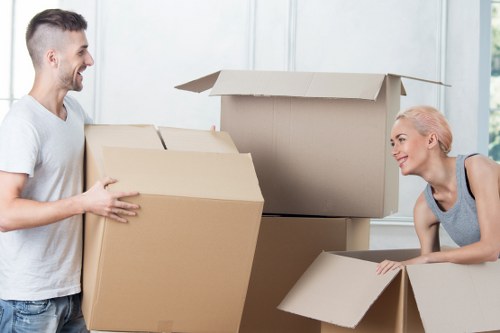 Movers handling boxes and furniture in a Pimlico street